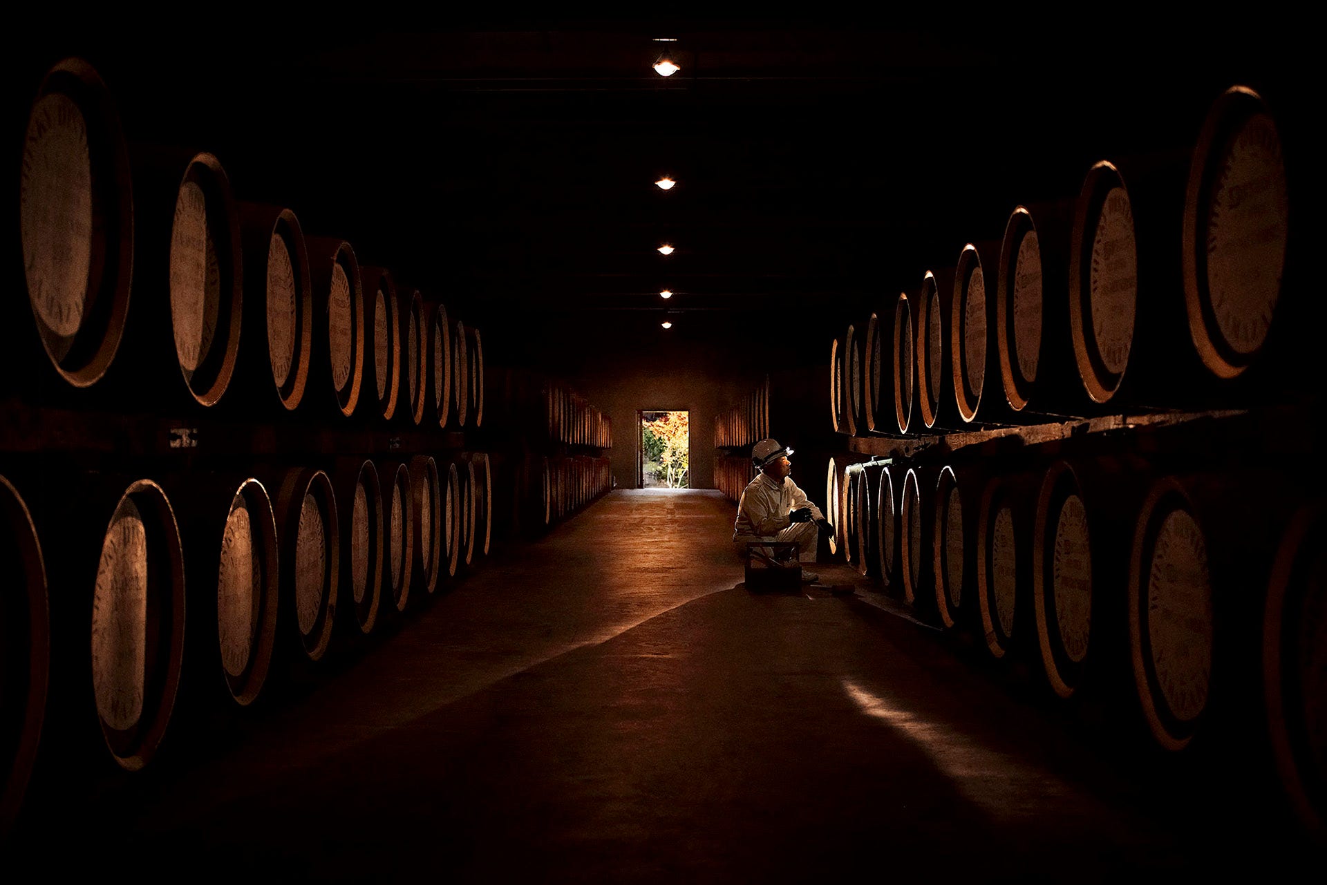 Dark shot of barrels with a door in the background