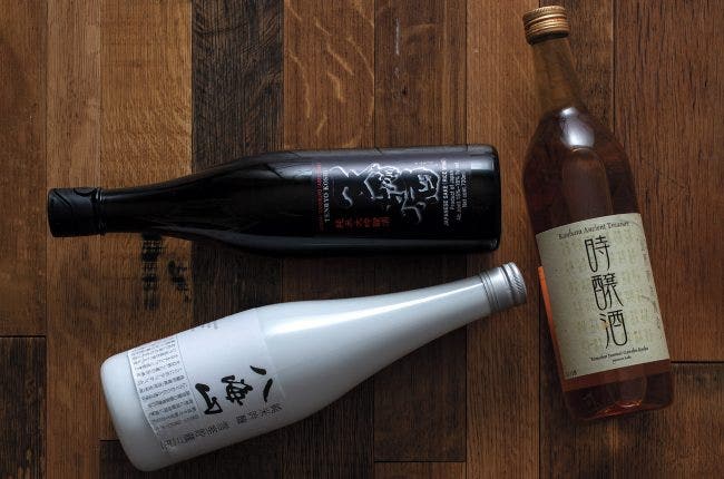 Three sake bottles on a table