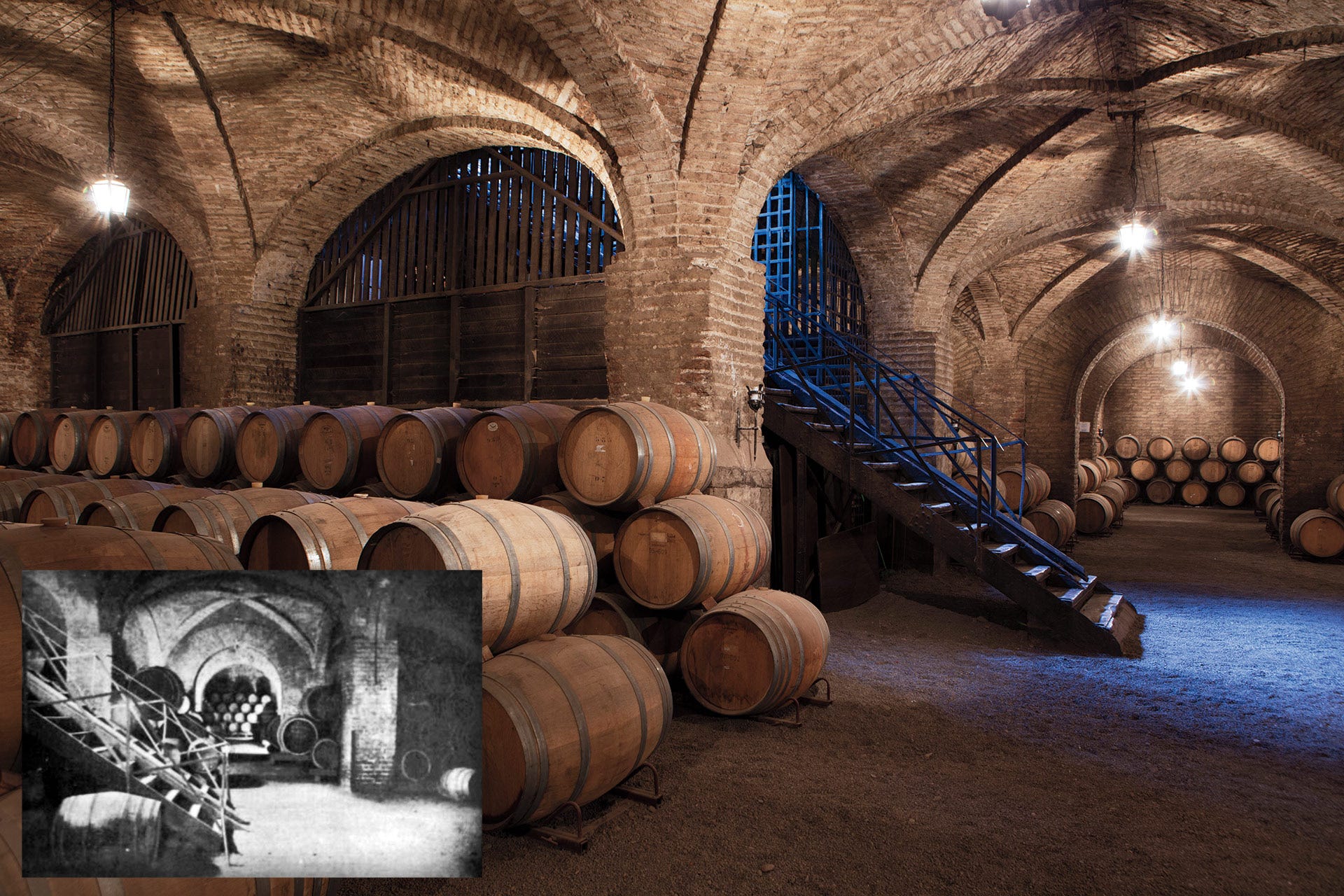 Brick arched underground cellar with stacked barrels