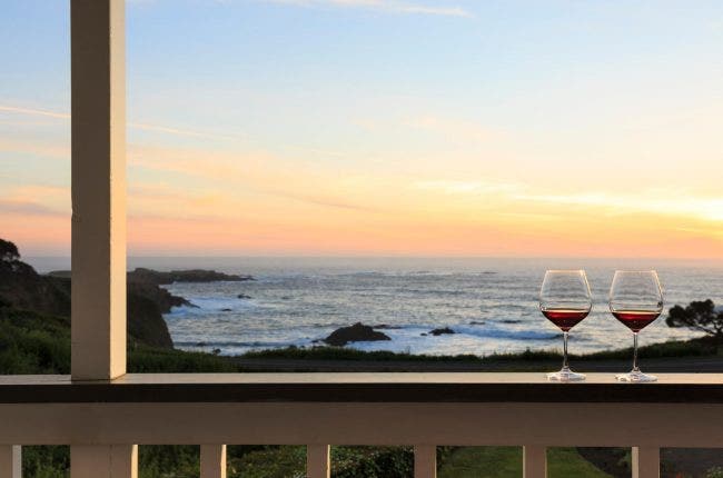 Two glasses of wine on a balcony, Pacific Ocean in the background