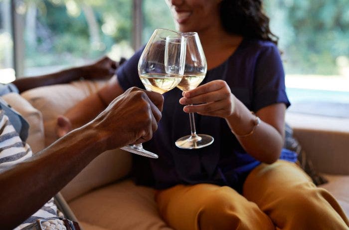 Man and a women toasting with white wine