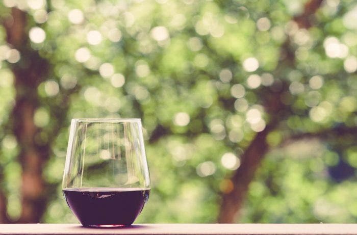 a glass of red wine in a window