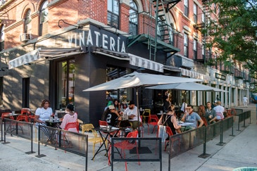 Vinateria exterior with patron at outdoor tables
