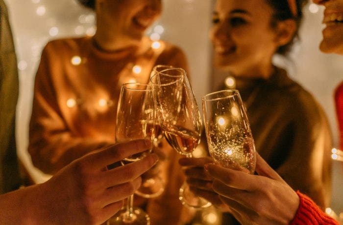 image of a group of friends toasting with champagne flutes_GettyImages-1280410383