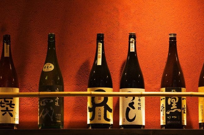 Sake bottles outside restaurant.