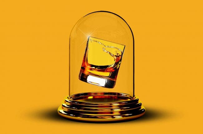 A glass of whiskey in a glass case