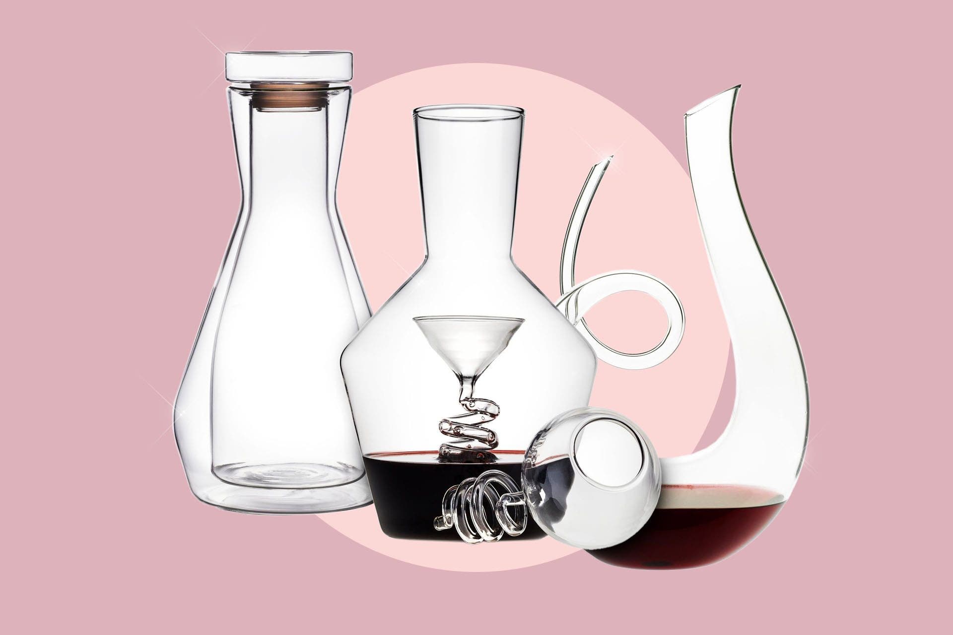 3 Wine Enthusiast decanters on a designed background